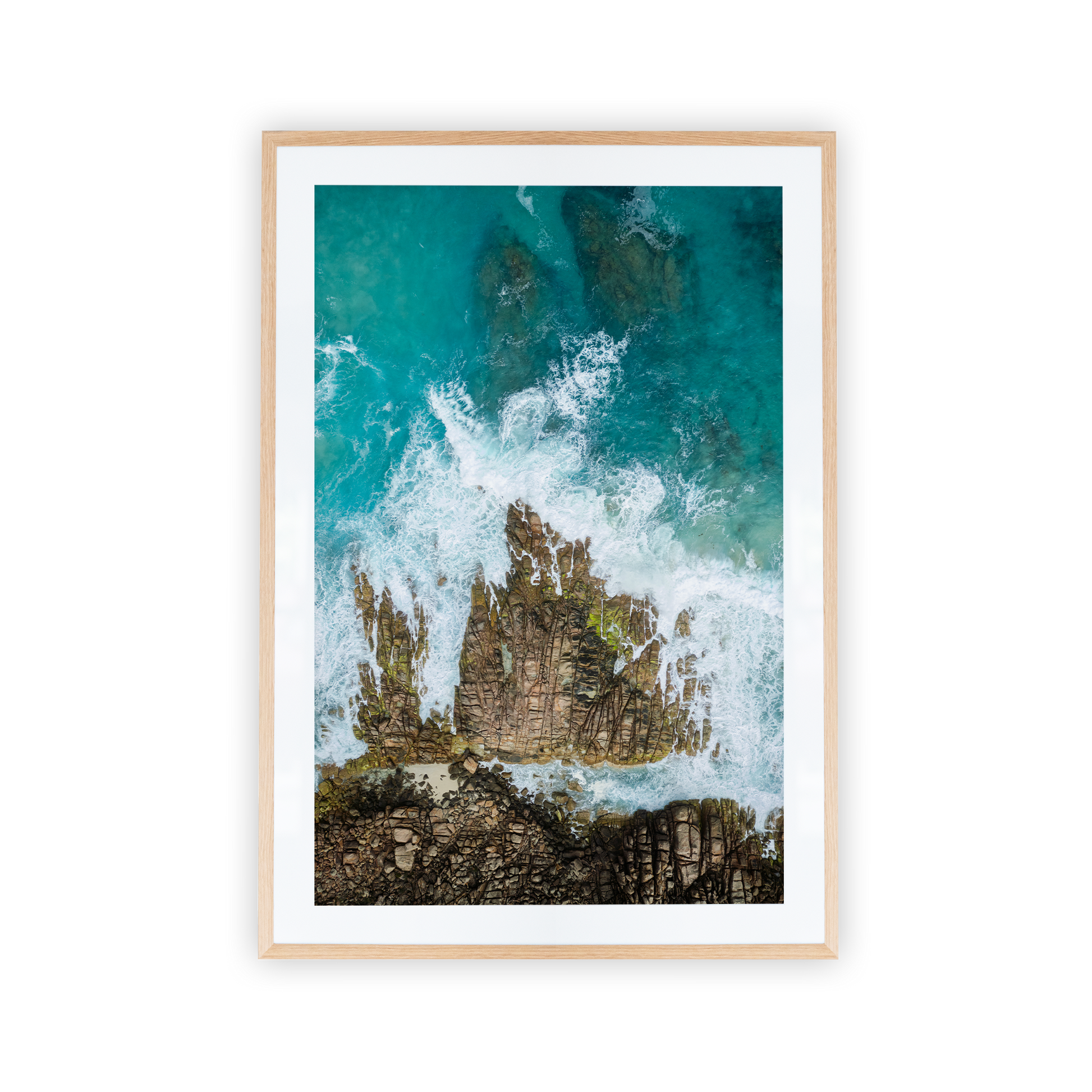 Aerial photo waves crashing into rocks
